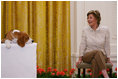 Mrs. Laura Bush smiles as the Westminster Kennel Club's 2008 Best in Show winner, Uno, is introduced to invited guests Monday, May 5, 2008, in the East Room during the beagle's visit to the White House Monday, May 5, 2008.