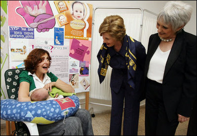 Mrs. Laura Bush and Mrs. Aliza Olmert, spouse of Israel's Prime Minister Ehud Olmert, greet a young mother in the Breast Feeding Education Room during a visit to the Tipat Chalav-Gonenim Neighborhood Mother and Child Care Center in Jerusalem Wednesday, May 14, 2008. There are 30 similar centers throughout the city providing prenatal, postnatal and preventative care and advice on breastfeeding, nutrition, immunizations and disease screening.