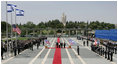 President George W. Bush and Mrs. Laura pause for the raising of the American flag Thursday, May 15, 2008, during arrival ceremonies at the Knesset in Jerusalem.