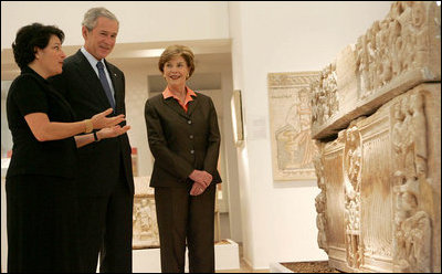 President George W. Bush and Mrs. Laura Bush listen as they're guided through the Bible Lands Museum Jerusalem Friday, May 16, 2008, by Director Amanda Weiss. The museum illustrates the cultures of all the peoples mentioned in the Bible and was founded by the late Dr. Elie Borowski, whose motto remains, "the future of mankind has its roots in the past, and only through understanding our history can we work together to create a better future for the generations to come".