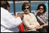 Mrs. Laura Bush and Mrs. Anita McBride, Assistant to the President and Chief of Staff to the First Lady, listen to Mr. Amir Ali, Hurghada Environmental Protection and Conservation Association, as they head out for a coral reefs and ocean conservation tour Saturday, May 17, 2008, in Sharm El Sheikh, Egypt.