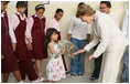 A young girl presents Mrs. Laura Bush with flowers before her departure Sunday, May 18, 2008, following a roundtable discussion with students on Big Read Egypt/U.S. at the Fayrouz Experimental School for Languages at Sharm El Sheikh.