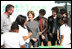 Surrounded by children participating in a soil sampling event, Mrs. Laura Bush speaks with Benjamin Jones, Director of Education, Trinity River Audubon Center, left during the First Bloom event at the Trinity River Audubon Center Sunday, November 2, 2008, in Dallas, TX. Mrs. Bush is joined by singer/songwriters the Jonas Brothers, Kevin Jonas, Joe Jonas, and Nick Jonas, right.