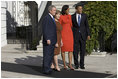 President George W. Bush and Mrs. Laura Bush welcome President-elect Barack Obama and Mrs. Michelle Obama to the White House Monday, Nov. 10, 2008, after the couple's South Portico arrival.