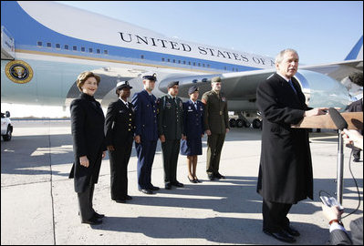 President George W. Bush, joined by Mrs. Laura Bush, stands outside Air Force One as he addresses his remarks in honor of Veterans Day, Tuesday, Nov. 11, 2008 upon the President's arrival at John F. Kennedy International Airport in New York. President Bush introduced military personnel representing the five branches of the armed services, who traveled with him aboard AF-1, honoring their service, from left are, U.S. Navy Chief Petty Officer Shenequa Cox of Dallas, Texas; U.S. Coast Guard Petty Officer First Class Christopher O. Hutto of Homer, Alaska; U.S. Army National Guard SSgt Michael Noyce-Merino of Melrose, Montana; U.S. Air Force Senior Airman Alicia Goetschel of Warrensburg, Mo., and U.S. Marine Corps Sgt. John Badon of Lufkin, Texas.