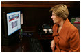 Mrs. Laura Bush, as part of her briefing Friday, Nov. 14, 2008 on the acid attack against young women on their way to school Wednesday in Kandahar, Afghanistan, reviews press footage about the incident in the East Wing at the White House.