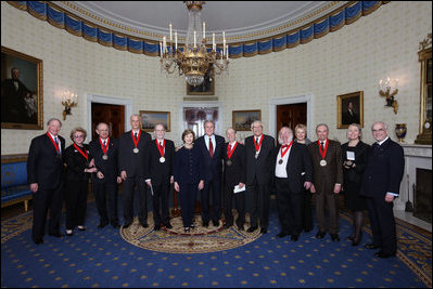 President George W. Bush and Mrs. Laura Bush stand with the recipients of the 2008 National Humanities Medal in the Blue Room at the White House Monday, Nov., 17, 2008. Pictured from left, Thomas A. Saunders III, president, and Jordan Horner Saunders, Board of Directors, North Shore Long Island Jewish Health Systems; Albert Marrin, author; Richard Brookhiser, Senior Editor, National Review; Harold Holzer, Senior Vice President for External Affairs, Metropolitan Museum of Art; Gabor S. Boritt, Director, Civil War Institute, Gettysburg College; Milton J. Rosenberg, WGN Radio Chicago; Myron Magnet, editor, City Journal; Adair Wakefield Margo, Presidential Citizen Medal recipient; Robert H. Smith, president, Vornado/Charles E. Smith; Laurie Norton, Director and CEO, Norman Rockwell Museum; Bruce Cole, Presidential Citizen Medal recipient.