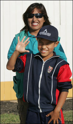 A very proud 8-year-old William Sebastian Hernandez Jeri holds up his hand to show how clean it is after demonstrating hand-washing techniques Friday, Nov. 21, 2008, for Mrs. Laura Bush at the San Clemente Health Center in San Clemente, Peru. Looking on is Ms. Nancy Quispitupa, Program Manager and Community Trainer.