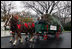 Sue Harman drives a horse-drawn carriage delivering the official White House Christmas tree Sunday, Nov. 30, 2008, to the North Portico of the White House. The Fraser Fir tree, from River Ridge Farms in Crumpler, N.C., will be on display in the Blue Room of the White House for the 2008 Christmas season.