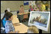 Mrs. Laura Bush watches during a visit to the fourth-grade classroom of Susan Weekes at the Riverside Elementary School in Bismarck, N.D., Thursday, Oct. 2, 2008, as Ms. Weekes shows students a painting by Emanuel Leutze of General George Washington crossing the Delaware River. The First Lady was visiting the school to highlight the National Endowment for the Humanities ' Picturing America' program which provides iconic artwork and photography for students to study.