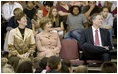 Mrs. Laura Bush enjoys a school assembly program, with Ms. Wilda Lu Nelson, Principal of the Riverside Elementary School, left, and Dr. Thomas Lindsay, Deputy Chairman of the National Endowment for the Humanities, during a visit to the school in Bismarck, N.D., Thursday, Oct. 2, 2008.