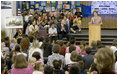 Mrs. Laura Bush addresses the Riverside Elementary School assembly in Bismarck, N.D., Thursday, Oct. 2, 2008, about the National Endowment for the Humanities' Picturing America' program. The program uses iconic artwork - such as the Washington Crossing the Delaware painting displayed nearby - and photography to teach children about architecture, art, and history as they discuss the images.
