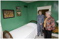 Mrs. Jean Coday, Director and President of the Laura Ingalls Wilder Historic Home and Museum, shows Mrs. Laura Bush the famous author's simple bedroom in Mansfield, Mo., Oct. 3, 2008. The home is where the "Little House" book series was written. Mrs. Bush, who is encouraging Americans to read our country's literary classics, noted that Laura Ingalls Wilder is an American author whose books have been loved by children and adults for over 70 years. The First Lady's mother read the books to her as a child before she could read. This week the home was designated a Save America's Treasures project.