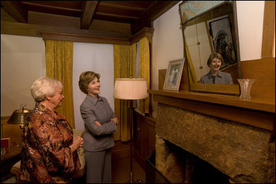 Mrs. Laura Bush looks at a portrait of Laura Ingalls Wilder and her husband on the Wilder home mantle Oct. 3., 2008, in Mansfield, Mo. Laura Ingalls married Almanzo Wilder in the summer of 1885 and moved to the Mansfield home where the "Little House" book series was written in 1894. Mrs. Jean Cody, Director and President of the Laura Ingalls Wilder Historic Home and Museum, explains that the mantle was something that the author really wanted to have. Her husband objected but obviously finally gave in. Wilder, who has been read by children and adults for over 70 years, is one of Mrs. Bush's favorite authors. The visit was used to help encourage American's to read their classic literature which defines us as a nation, reflects our history and bring us together by expressing our shared ideals.