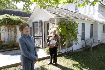 Mrs. Laura Bush talks with press outside the Mansfield, Mo., home of author Laura Ingalls Wilder after Mrs. Jean Coday, Director and President of the Laura Ingalls Wilder Historic Home and Museum, offered the First Lady a tour of the modest home. The home was designated this week as a Save America's Treasures project, which is in partnership with the National Trust for Historic Preservation. Mrs. Bush noted that Wilder, who wrote the "Little House" book series, was one of her favorite authors. "My mother read them to me when I was little before I could read," she said.