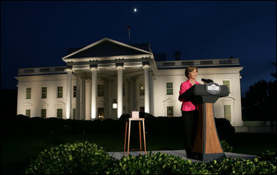 Mrs. Laura Bush prepares to push the button, Oct. 7, 2008, to light up the White House in a pink glow as part of Breast Cancer Awareness. Preventing and curing breast cancer is a cause that Mrs. Bush has worked toward around the world.