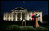 Mrs. Laura Bush prepares to push the button, Oct. 7, 2008, to light up the White House in a pink glow as part of Breast Cancer Awareness. Preventing and curing breast cancer is a cause that Mrs. Bush has worked toward around the world.