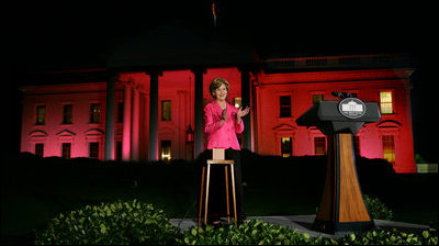 Mrs. Laura Bush applauds after pushing the button to flood the north front of the White House with a sea of pink, in honor of Breast Cancer Awareness Month, on Oct. 7, 2008. Bush addressed breast cancer survivors and advocates and members of the diplomatic corps just before the light display. The First Lady has encouraged worldwide efforts in preventing and curing a disease that is the leading cause of death in women. Each year more than 1.2 million people worldwide are diagnosed with breast cancer. The United States is working with countries in the Middle East, Europe and the Americas to empower women to take control of their health, raise awareness about the importance of prevention and early diagnosis, and support collaborative research to find a breast cancer cure.