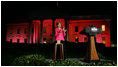 Mrs. Laura Bush applauds after pushing the button to flood the north front of the White House with a sea of pink, in honor of Breast Cancer Awareness Month, on Oct. 7, 2008. Bush addressed breast cancer survivors and advocates and members of the diplomatic corps just before the light display. The First Lady has encouraged worldwide efforts in preventing and curing a disease that is the leading cause of death in women. Each year more than 1.2 million people worldwide are diagnosed with breast cancer. The United States is working with countries in the Middle East, Europe and the Americas to empower women to take control of their health, raise awareness about the importance of prevention and early diagnosis, and support collaborative research to find a breast cancer cure.