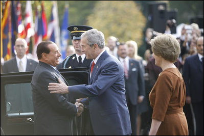 President George W. Bush and Mrs. Laura Bush welcome Italian Prime Minister Silvio Berlusconi upon his arrival Monday, Oct. 13, 2008 to the White House.