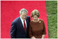 President George W. Bush and Mrs. Laura Bush stand together as they wait for the arrival of Prime Minister Silvio Berlusconi of Italy Monday, Oct. 13, 2008, during a South Lawn ceremony for the Prime Minister at the White House.