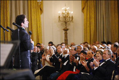 President George W. Bush and Mrs. Laura Bush are joined by Italian Prime Minister Silvio Berlusconi Monday evening, Oct. 13, 2008, as they listen to the Broadway cast of the Jersey Boys perform in the East Room of the White House.