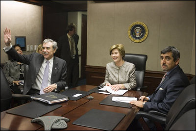 Mrs. Laura Bush acknowledges the Ladies in White during a video teleconference Thursday, Oct. 16, 2008, in the Situation Room of the White House. Mrs. Bush is joined by U.S. Secretary of Commerce Carlos Gutierrez, waving left, and interpreter Manuel Quiroz. Mrs. Laura Bush conveyed her continuous commitment, and that of the President, to support the Cuban people's aspirations for freedom.