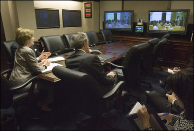 Joined by U.S. Secretary of Commerce Carlos Gutierrez, right, Mrs. Laura Bush talks with the Ladies in White via a video teleconference Thursday, Oct. 16, 2008, in the Situation Room of the White House. The Ladies in White is an organization that includes spouses and other relatives of jailed Cuban dissidents. The organization was formed in 2003 to protest the arrest of 75 dissidents by the Cuban regime. Members of the organization have been consistently detained, threatened, and at times beaten by police during their peaceful protests.