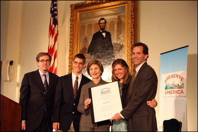 Mrs. Laura Bush presents the Fifth Annual Preserve America History Teacher of the Year award to David Mitchell, right, Friday, Oct. 24, 2008, at the Union League Club in New York City. She is joined by Dr. James Basker, President, Gilder Lehrman Institute of American History, left, and David Mitchell's students from Masconomet Regional High School in Boxford, Mass., David Burbank, 17, and Molly Byman, 18. The award notes the importance of teaching history and highlights the Preserve America initiative.