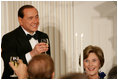 Prime Minister Silvio Berlusconi of Italy, seated next to Mrs. Laura Bush, acknowledges a toast offered in his honor by President George W. Bush Monday eveing, Oct. 13, 2008, at the White House State Dinner in honor of Berlusconi's visit to Washington, D.C.