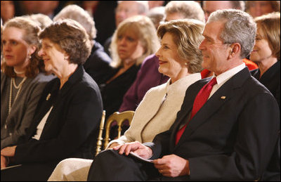President George W. Bush and Mrs. Laura Bush listen Monday evening, Oct. 27, 2008 in the East Wing of the White House, to the performance of Theodore Roosevelt impersonator Joe Wiegand, during a celebration of the 150th birthday of Theodore Roosevelt.