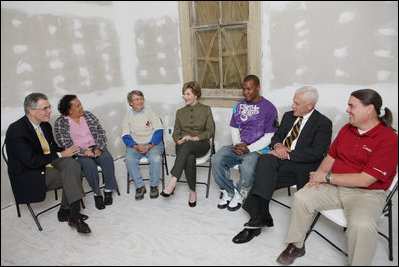 Mrs. Laura Bush visits with Mr. Jim Kelly, CEO and co-president of Catholic Charities Archdiocese of New Orleans, left; homeowner Mrs. Joeretta Roman, Ms. Nancy Parlin, Consociate Candidate, Sisters of St. Joseph of the Province of St. Paul, third from left; Mr. Ashton Johnson, student YouthBuild Helping Hands; Mr. Doug O'Dell, Federal Coordinator, Office of the Federal Coordinator for Gulf Coast Rebuilding, 2nd right, and Mr. Kevin Fitzpatrick, Volunteer Housing Coordinator, Operation Helping Hands, right, Thursday, October 30, 2008, in New Orleans, La., during a tour of the home of Joretta Roman which is being rennovated by Catholic Charities Operation Helping Hands after sustaining damage from Hurrican Katrina.