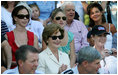 Mrs. Laura Bush is joined by her daughters, Barbara, background-left, and Jenna, background-right, as they watch action at the Tee Ball on the South Lawn: A Salute to the Troops game Sunday, Sept. 7, 2008 at the White House, played by the children of active-duty military personnel.