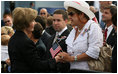 Mrs. Laura Bush speaks with a family member attending the Pentagon Memorial dedication ceremony Thursday, Sept. 11, 2008 at the Pentagon in Arlington, Va., where 184 memorial benches were unveiled honoring all innocent life lost when American Airlines Flight 77 crashed into the Pentagon on Sept. 11, 2001.