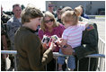 Mrs. Laura Bush offers photos of the Bush family dogs, Scottish Terrier's Barney and Mrs. Beazley, and the cat, Willie, to a little girl before departing from Forbes Field in Topeka, Kan., on Tuesday, Sept. 16, 2008. She had just greeted members of the military gathered to see her departure from the air field.