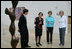 Mrs. Laura Bush is given a tour of the Nasher Sculpture Center by Acting Chief Curator Jed Morse, left, Trustee Nancy Nasher, second from left, and Debbie Francis, right, on Friday, Sept. 19, 2008, in Dallas.