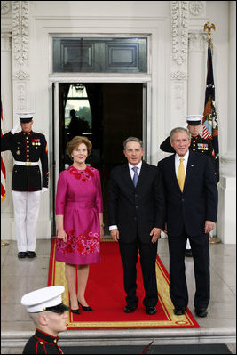 President George W. Bush and Mrs. Laura Bush greet Colombian President Alvaro Uribe on the North Portico Saturday, Sept. 20, 2008, for a social dinner at the White House.