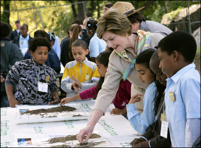 Mrs. Laura Bush and children from the Adam Clayton Powell Jr. Elementary School (P.S. 153) and the Boys and Girls Club of Harlem do a 'soil sampling' as part of the First Bloom program at the Hamilton Grange National Memorial in New York City, Sept. 24, 2008. The activity helps children learn about the characteristics of local soil and thus the kinds of plants best suited to the area. The park is the historic home of Alexander Hamilton. 