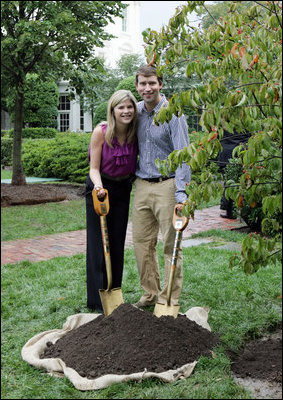 Jenna Hager, daughter of President George W. Bush and Mrs. Laura Bush, and husband Henry Hager pose for a photo after shoveling dirt onto a Cherokee Princess Dogwood during a commemorative tree planting ceremony Saturday, Sept. 27, 2008, on the South Lawn of the White House.