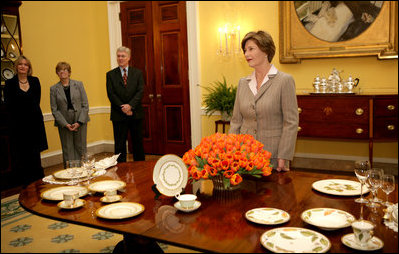 Mrs. Laura Bush meets reporters as she announces two new White House china patterns, Wednesday, Jan. 7, 2009 in the Family Dining Room of the State Floor of the White House for their unveiling of the George W. Bush State China and the Magnolia Residence China. The George W. Bush State China was inspired from a Madison-era dinner service. The Magnolia Residence China is in the picture foreground and the George W. Bush State China is on the left side of the table. With Mrs. Bush from left are Amy Zantsinger, White House Social Secretary, Nancy Clarke, White House Florist, and Bill Allman, White House Curator.
