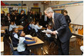 President George W. Bush talks with a young student during his visit with Mrs. Laura Bush to a second grade class Thursday, Jan. 8, 2009 at the General Philip Kearny School in Philadelphia. President Bush followed his class visit with an address on the No Child Left Behind Act, urging Congress to strenghten and reauthorize the legislation.