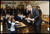 President George W. Bush talks with a young student during his visit with Mrs. Laura Bush to a second grade class Thursday, Jan. 8, 2009 at the General Philip Kearny School in Philadelphia. President Bush followed his class visit with an address on the No Child Left Behind Act, urging Congress to strenghten and reauthorize the legislation.