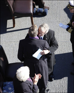 President George W. Bush embraces his father, former President George H. W. Bush, following his remarks honoring his father during the commissioning ceremony of the USS George H. W. Bush (CVN 77) aircraft carrier Saturday, Jan 10, 2009 in Norfolk, Va.
