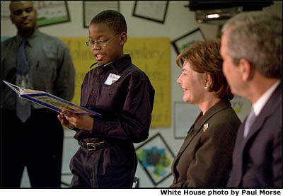 A Moline Elementary School student reads for President Bush and Mrs. Bush. (St. Louis, Missouri, February 20, 2001) White House photo by Paul Morse.