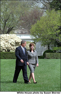 President Bush and Mrs. Bush walk across the South Lawn of the White House to board Marine One en route to the Summit of the Americas in Quebec City, Canada. (April 20, 2001) White House photo by Susan Sterner.