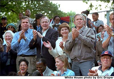 President Bush and Mrs. Bush applaud a well-played game of tee-ball on the South Lawn of the White House. Joined by the President's father, former President George Bush, the President's mother, Barbara Bush, and the President's brother, Florida Governor Jeb Bush, the First Family encourages young children to be physically active and sponsors games at the White House about once a month. (June 3, 2001) White House Photo by Eric Draper.