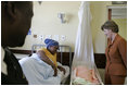 Laura Bush visits with a mother and her newborn baby while meeting with the group, "Mothers to Mothers-to-Be," in Cape Town, South Africa, Tuesday, July 12, 2005. The program provides support to HIV-positive women during their pregnancy. 