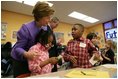 Laura Bush talks with Providence Family Support Center after-school program participants Isaiah Baynes, right, and Carlaija Whitehead during her visit and President Bush's to Pittsburgh to highlight the program's efforts to help area youth Monday, March 7, 2005.