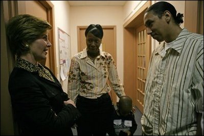 Laura Bush speaks with Kenyatta "Ken" Thigpen, his girlfriend Jewell Reed and their three-year-old son, Kevion, during a visit to the Rosalie Manor Community and Family Services center in Milwaukee, Wis., Tuesday, March 8, 2005. Mrs. Bush credits a New York Times article by Jason DeParle about Mr. Thigpen's determination to be a responsible father with bringing her attention to the needs of boys and young men.
