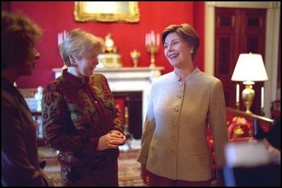 Laura Bush shares a light moment with Ludmila Putina, wife of Russian Federation President Vladimir Putin, in the Red Room of the White House the Saturday, October 12, 2002 prior to the opening ceremony of the Second Annual National Book Festival.